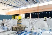 Inspiration: open-air marquee reception with white chairs, glassware and yellow floral centerpieces